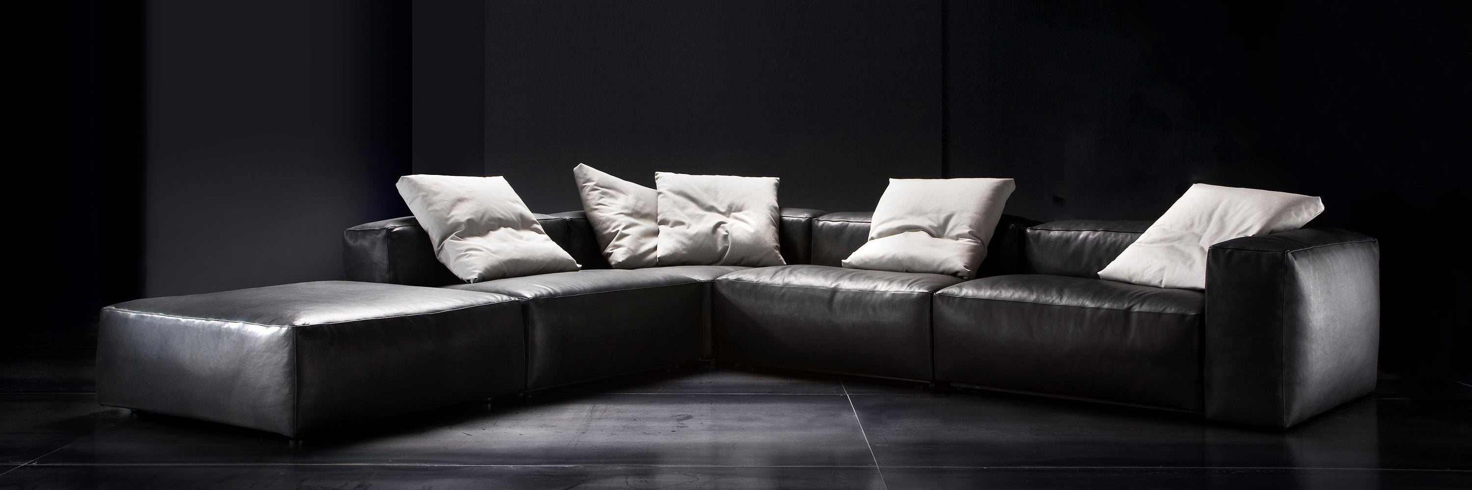 Aspettami in black leather modular furniture collection in Italy showroom.