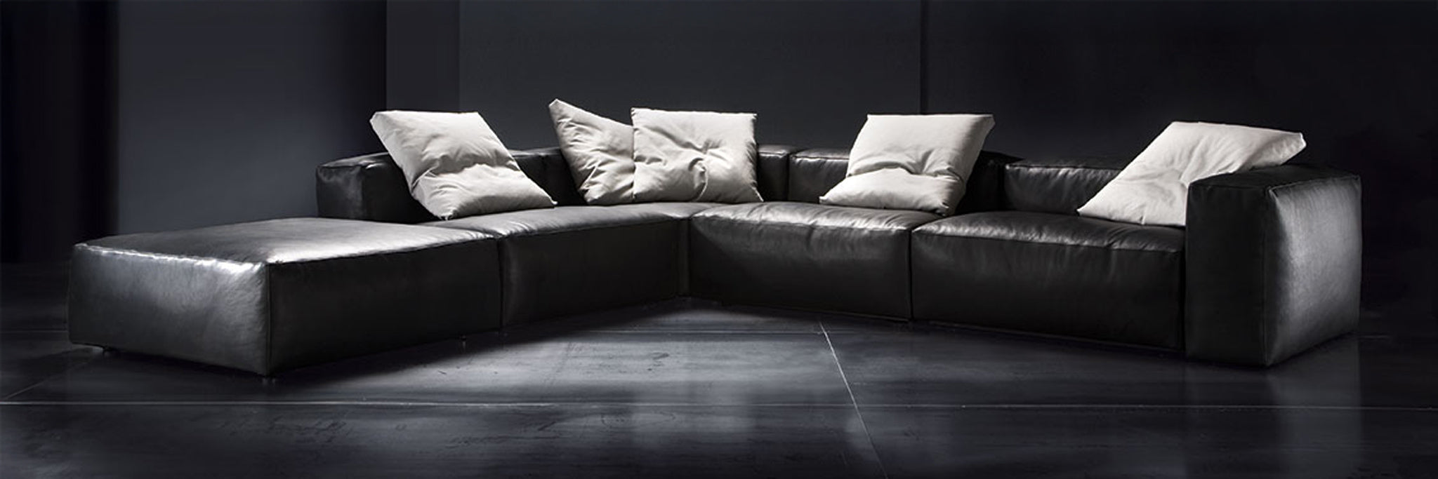 Aspettami modular furniture collection in black leather at Italian showroom.