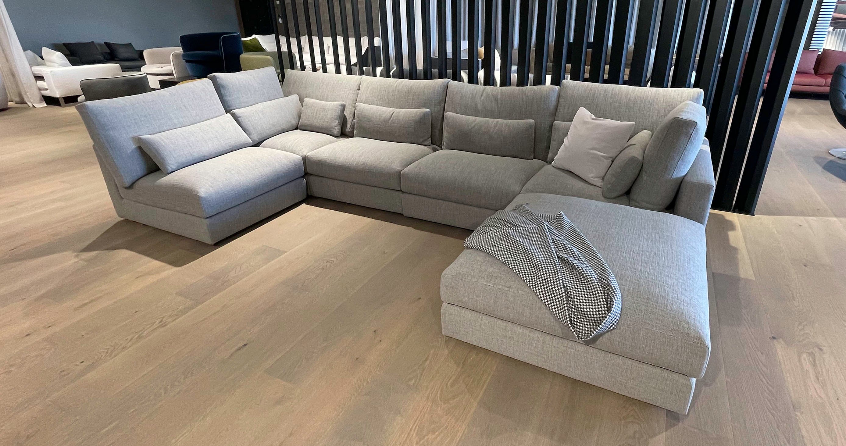 Grey coloured modular Italian furniture collection on wooden showroom floor at Design Italia NZ