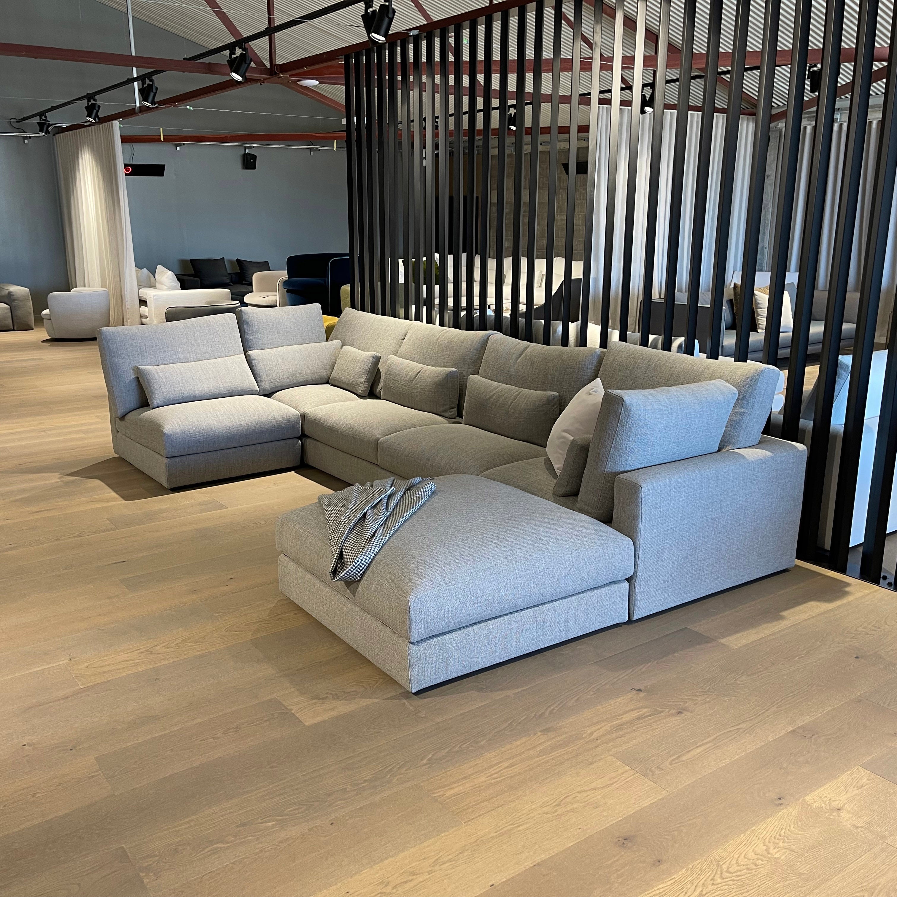 Portofino Grande modular furniture collection in fog colour fabric on Design Italia showroom floor