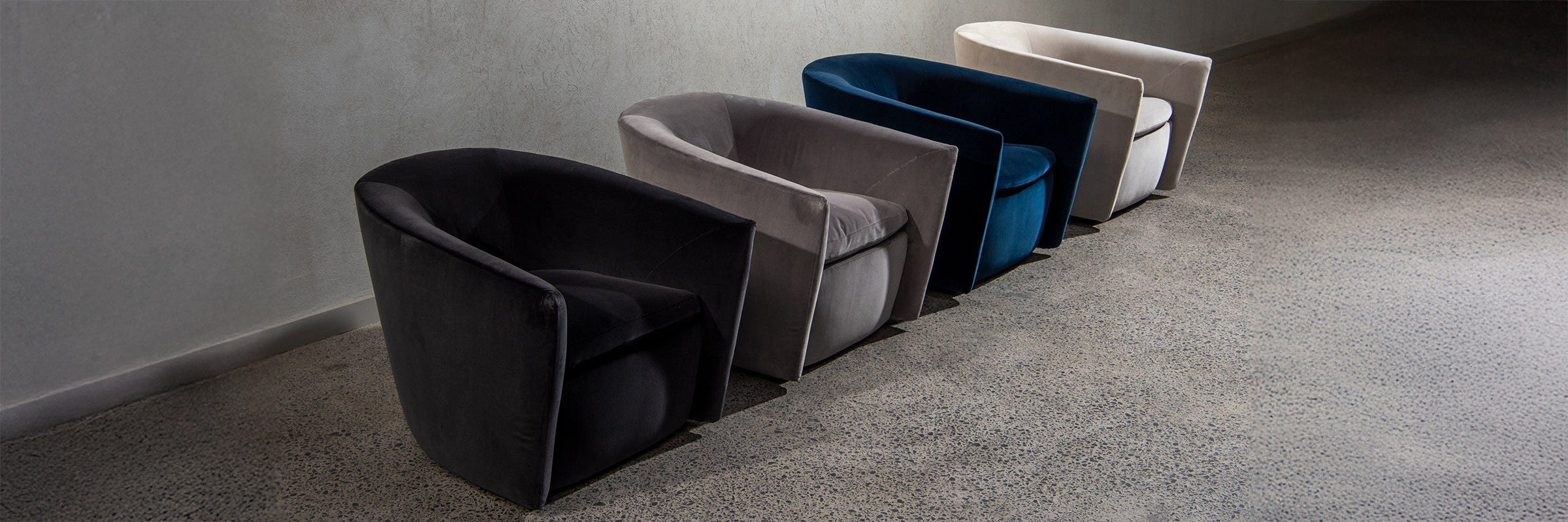 Four Roma chairs in different colours all in row in showroom.