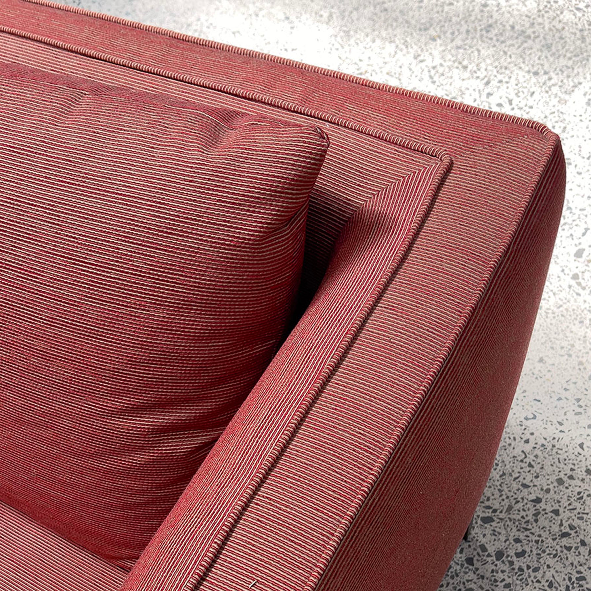 Close up of fabric on Siena sofa in Rosso burgundy colour with pillow, arm and back shown.
