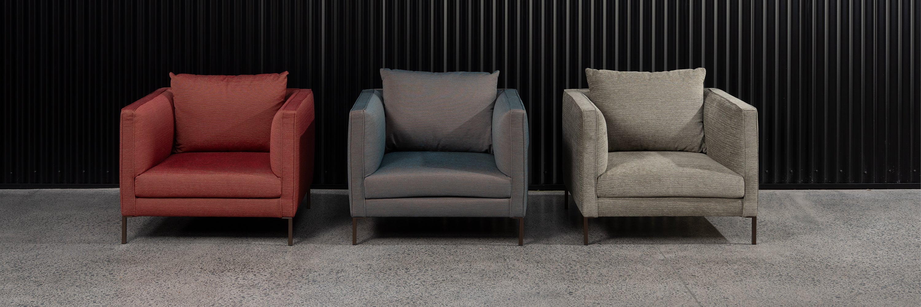 Three Siena armchairs in a row in showroom. 